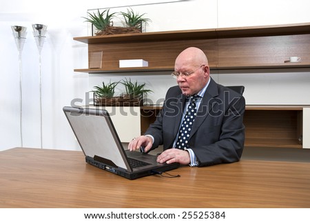 A company director typing on his laptop