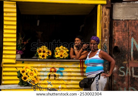 HAVANA, CUBA - JANUARY 1, 2014: Two Cuban women at a small floral shop in Old Havana, Havana, Cuba. Old Havana is city-center and one of the 15 municipalities forming Havana, Cuba