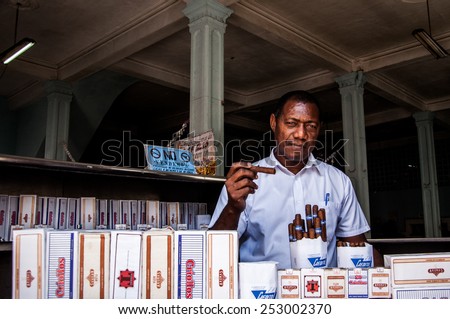 HAVANA, CUBA - JANUARY 1, 2014: A tobacco and cigar shop owner in Old Havana, Havana, Cuba. Old Havana is city-center and one of the 15 municipalities forming Havana, Cuba