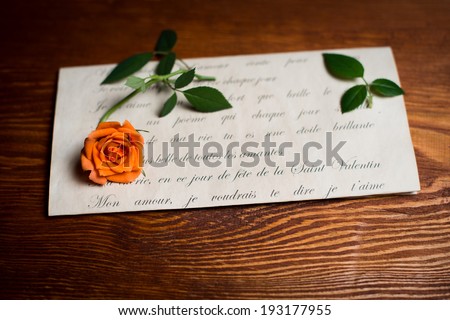 Romantic love letter and rose on wood. ValentineÃ¢Â?Â?s day background.