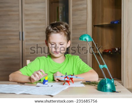 Creating the model plane. Happy boy making aircraft model. Hobby concept.