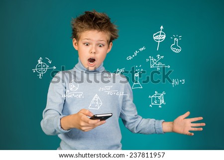 Education school and technology concept. Surprised boy with smartphone on blue background.