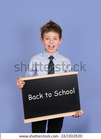 Back to School - Boy with Blackboard Slate on Blue Background.