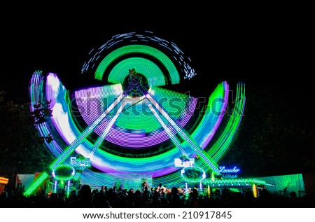 Kreuzlingen, Switzerland - August 9, 2014: people at an event with roller coasters, flat rides and carousels called 