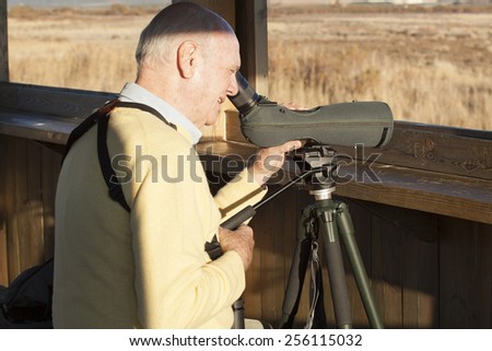 Bird Watcher looking through a telescope