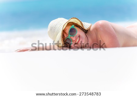 Art photo of a beautiful lady in hat on the sand beach