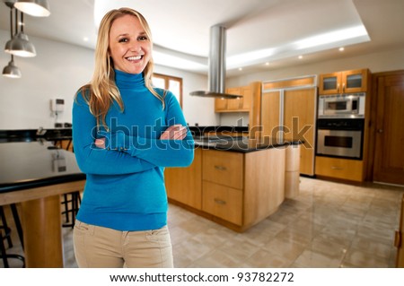 Young happy woman at her big new kitchen