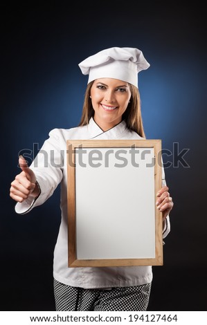 Young woman chef holding white banner