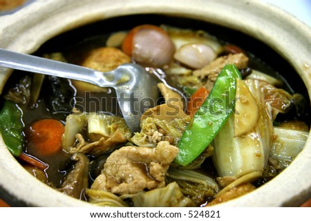 A mixture of vegetables boiled and served in a hot pot, still simmering.
