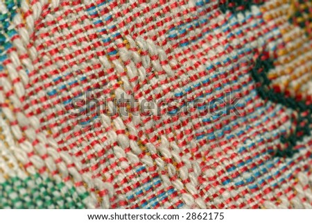 Close up view of colorful fabric weave from a cushion cover