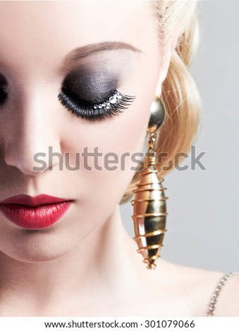 Beautiful false eye lashes with make up. Face close up.