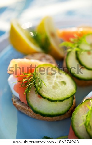 Canapes with smoked salmon, fresh cucumber, creamy cheese and dill