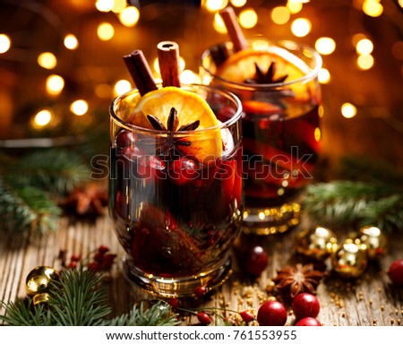 Christmas mulled red wine with spices and fruits on a wooden rustic table. Traditional hot drink at Christmas time Сток-фото © 