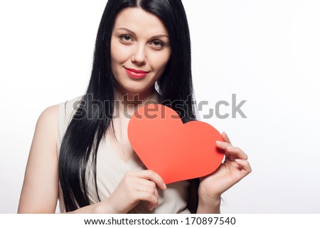 Valentine Day concept. Beautiful young smiling woman with a gift in the form of heart in her hands. Closeup fashion portrait.
