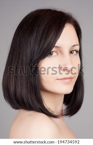 Close-up portrait of young beautiful woman with short hairstyle. Beautiful haircut. Short straight hair.