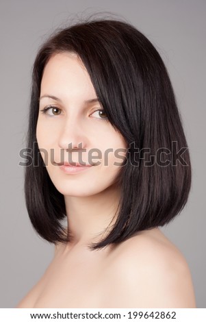 Close-up portrait of young beautiful woman with short hairstyle. Beautiful haircut. Short straight healthy hair.