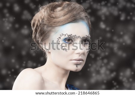 Creative, unusual closeup portrait of Snow Queen. Creative Winter Makeup. Perfect Beautiful Girl\'s Face. Beautiful christmas princess. Winter concept