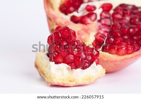 Ripe juicy pomegranate fruit on white background cutout