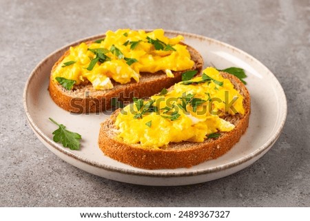 Similar – Image, Stock Photo Scrambled eggs in a blue plate, top view on a yellow table.