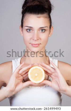 Beautiful close-up young woman with lemons. Healthy food concept. Skin care and beauty. Vitamins and minerals.