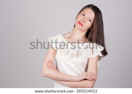 Beautiful close-up portrait of an young woman with short brown haircut wearing red lipstick on studio background. Haircut. Beautiful Girl with Healthy Straight Blond Hair. Hairstyle