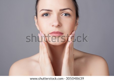 Close-up portrait of a beautiful young woman. Skin care concept. Natural look. Beauty portrait. Spa and health.