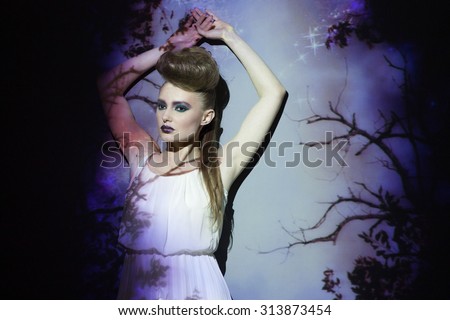 Fashion, creative portrait, woman with color image on her face and body. Image projection.