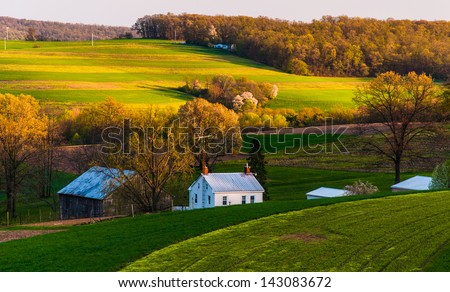 Home and barn on the farm fields and rolling hills of Southern York County, Pennsylvania.