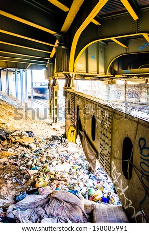 Trash under the Howard Street Bridge in Baltimore, Maryland.