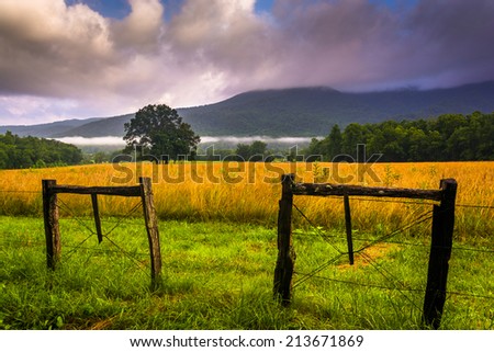 Fence and low clouds over mountains, at Cade's Cove, Great Smoky Mountains National Park, Tennessee.