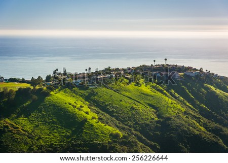 View of green hills and houses overlooking the Pacific Ocean, in Laguna Beach, California.