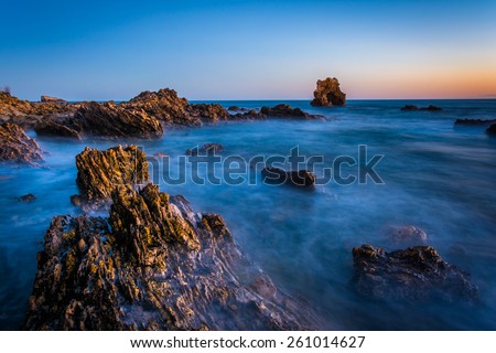 Long exposure of water and rocks at twilight, at Little Corona Beach, in Corona del Mar, California.