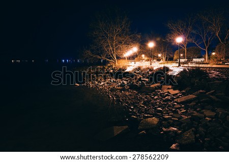 Lamps and rocks along the shore of the Chesapeake Bay at night, in Havre de Grace, Maryland.