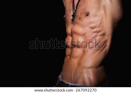 Muscular and sexy torso of young sporty man with perfect abs