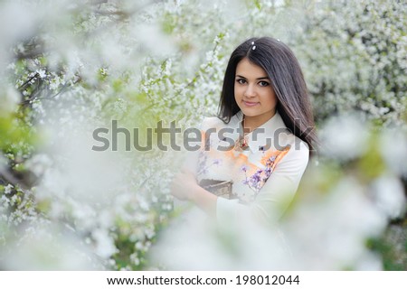 Cute girl walks in the spring garden
