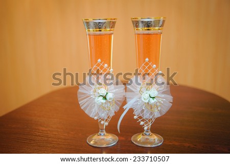two glasses with champagne standing on the table