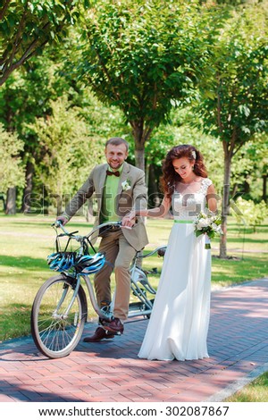 Bride and groom on tandem bike