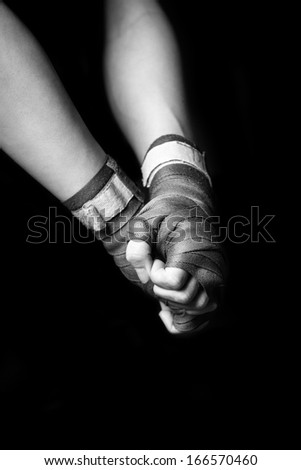 Woman with hands wrapped for kickboxing.