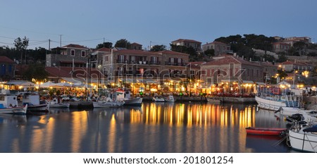 MOLYVOS, LESVOS, GREECE - JUNE 12, 2014: Holiday makers dining in harbor side restaurants Molyvos Greece