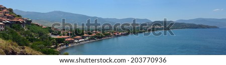 MOLYVOS, LESVOS, GREECE - JUNE 11, 2014: Hotels restaurants and bars on the seafront in the popular desitination of Molyvos including The Olive Press Hotel.