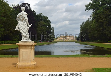 SILSOE, BEDFORDSHIRE, ENGLAND - JULY 21, 2015: Wrest park French style mansion, long water and statue of William of Orange.