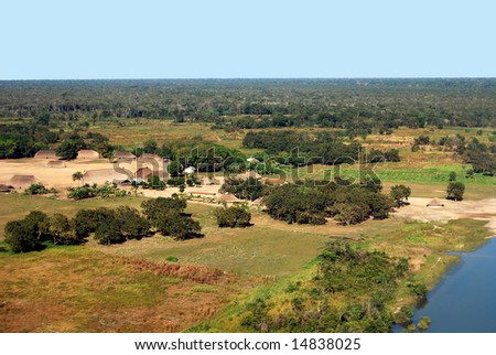 Aerial of traditional Amazon Indian village with houses in circle near Xingu River in Brazil