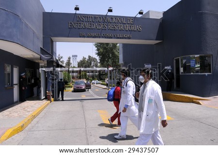 MEXICO CITY - APRIL 28: Hospital workers walk past the main entrance of the Mexican Institute of Respiratory Illnesses on April 28, 2009 in Mexico City. Concern over the Swine Flu spreads worldwide.