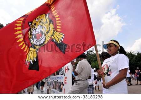 WASHINGTON - JULY 4: A woman holds the Tamil Tigers flag in a rally in front of the White House in Washington on July 4, 2009. The rally blamed Sri Lanka for human rights violations against Tamils.