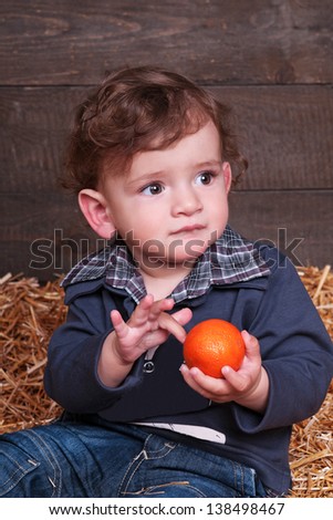 funny lovely baby boy little child in trendy jeans on hay. happy  kid playing game. Cute adorable child baby American boy. Beautiful expressive laughing smiling baby infant toddler