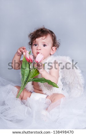 funny lovely baby boy little child with angel wings and nimbus. happy  kid playing game. Cute adorable child baby American boy. Beautiful expressive laughing smiling baby infant toddler