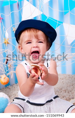 happy funny lovely baby girl little child in a suit of the seaman smiling and having fun. happy kid playing game. Cute adorable child baby American girl. expressive laughing baby infant toddler