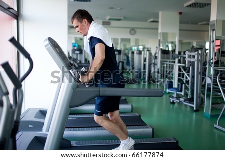 Healthy man a treadmill in a sport center