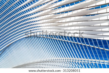 Transparent ceiling in modern railway station with blue sky on a background