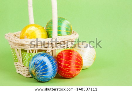 Christmas Ornaments in a Basket - A set of brightly colored Christmas ornaments is placed on and around a basket. Can be used as a background or in Christmas cards.